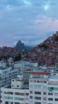 Cantagalo and Pavao-Pavaozinho Favelas on Cloudy Morning. Rio de Janeiro, Brazil. Aerial View. Drone Flies Upwards, Tilt Down. Crane Shot. Vertical Video