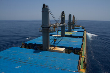 A merchant ship underway at sea on a sunny day