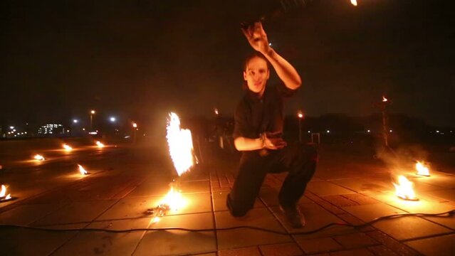 Boys dance showing different tricks with burning pois rotation