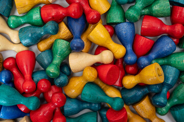 Multi colored pawns on table making diverse background