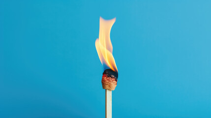 Single matchstick burning against blue background, symbolizing burnout and stress management.