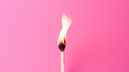 Single matchstick burning against pink background, symbolizing burnout and stress management.