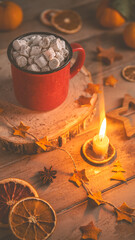 Cute cozy winter composition. red mug, marshmallows, oranges and Christmas lights.