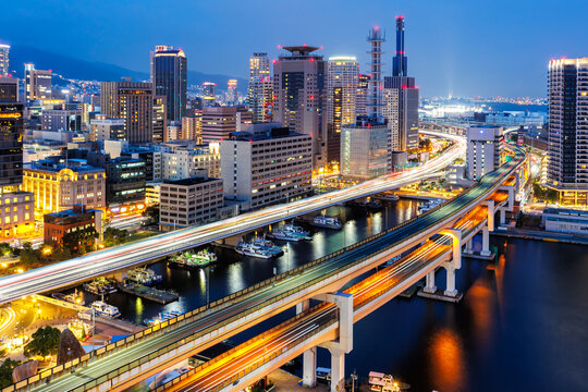 Kobe skyline from above with port and elevated road at twilight in Japan