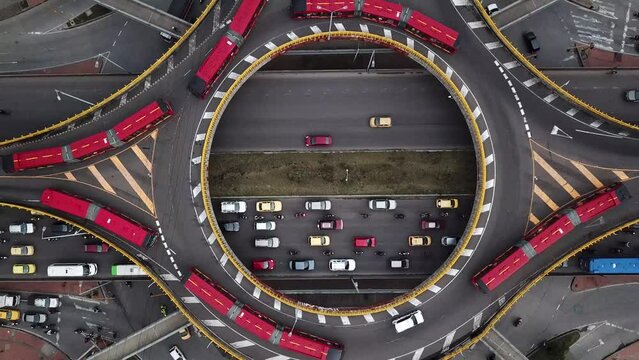 Aerial drone shot of Roundabouts in Bogota, Colombia, Latin America. Traffic in Bogota, Transmilenio. Dedicated busway on the top level. Famous roundabout full of red buses. High quality 4k footage.