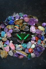 set of Gemstones minerals and tropical butterfly on dark abstract background close up. Different...