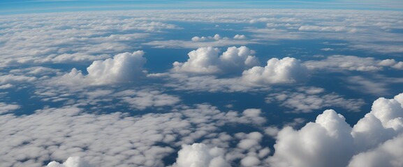 Aerial View of Fluffy Clouds in a Blue Sky, Aerial of airplane in blue sky with fluffy white clouds. "A mesmerizing aerial view of fluffy clouds floating against a serene blue sky."