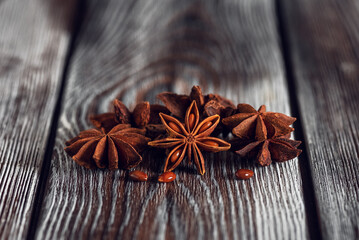 Close-up of star anise on a wooden old background. Selective focus, copy space.