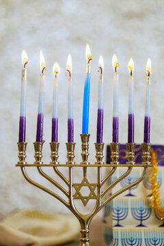 During Hanukkah Hanukkiah Menorah candles is lit as symbol of Jewish religious beliefs.