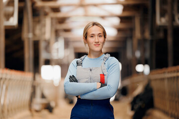 Agriculture industry, farming livestock cattle. Happy smiling young woman farmer in bard of cows on...