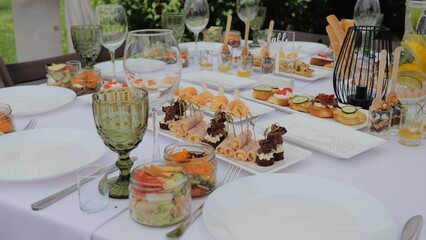 Business lunch. A beautiful festive table covered with a variety of food. Food and drinks on the festive table in the restaurant. Beautifully decorated banquet table with appetizers.