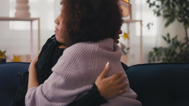 Young woman supporting and hugging her crying best friend, female friendship