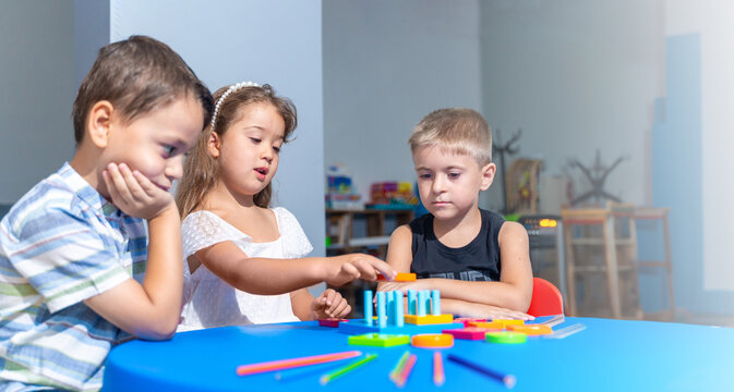 Happy Diverse School Children Having Educational Class Sitting At Desk In Classroom At School Or Kindergarten . Modern Education And Knowledge Concept. Kindergarten playtime activities