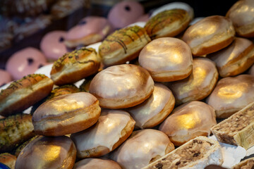 Fototapeta na wymiar A variety of delicious donuts stacked up for sale on a market stall