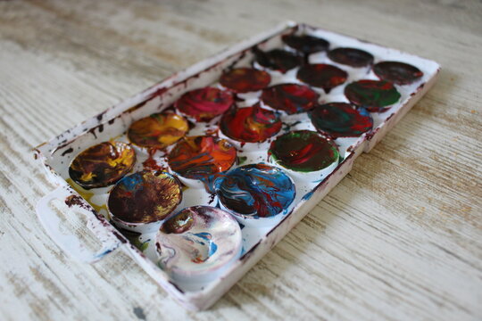 Box of colorful mixed watercolor paints. Children's creativity