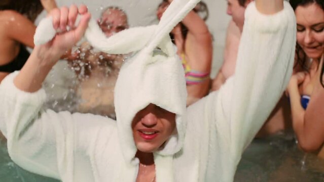 Guy in rabbit costume dancing at pool with five other young gays