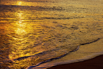 It is during early morning hours of day that sun rises over ocean waves