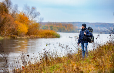 Traveler on nature landscapes. Autumn hiking vacation.