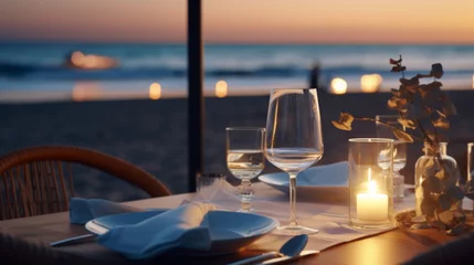 Fotobehang Strand zonsondergang Romantic dinner setting on the beach at sunset