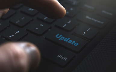 Close-up: Hand on keyboard, clicking 'Update' button. Streamlined upgrades for a seamless user experience.