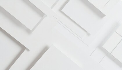 Abstract white geometric shapes creating a three-dimensional effect on a plain background.