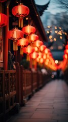 Naklejka premium As dusk sets in a series of red lanterns with intricate designs illuminates a temple pathway. The depth of field leads the eye through a tranquil journey