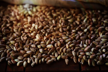 Roasted salted pistachios. Dried pistachios in small sack on  table.