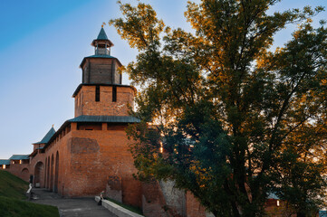 Fototapeta na wymiar Fragment of the fortress wall of the Nizhny Novgorod Kremlin with the Clock Tower Nizhny Novgorod, Russia