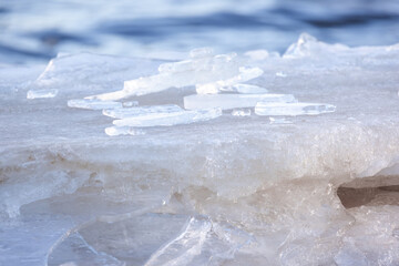 Ice shards lay at the coast of frozen Baltic Sea on a winter day, close up
