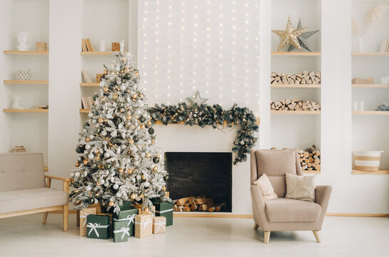 Christmas Interior Decorated photo zone along with christmas tree, gift boxes, sofa, shelf and fireplace