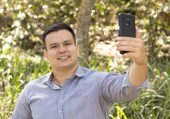 man taking a photo in nature