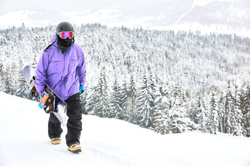 One more time. Snowboarder with his board is going back on the top hill for the next ride. Wear...