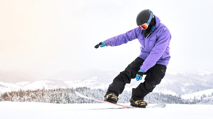 Try this one. Male snowboarder trying to make his trick with a snowboard on the top of the mountain