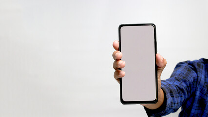 A hand is holding a phone with an empty white screen for copy space, isolated on a white background