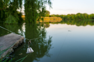 A bell on a fishing line. Background with selective focus and copy space
