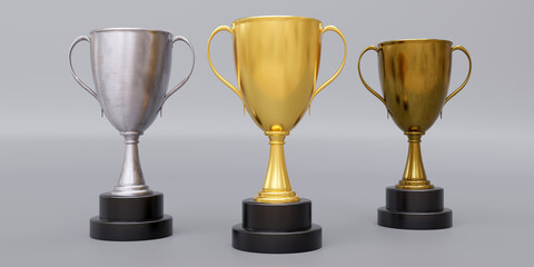 Gold silver bronze trophy cup with dual handle on grey background. Shiny metallic reward. 3d render