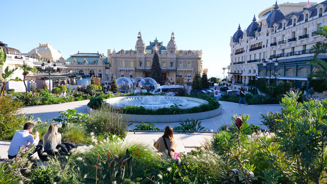 Majestic exterior of the Monte Carlo Casino, showcasing its stunning architecture and vibrant atmosphere. A summer day in Monaco, where luxury and elegance come to life against a dazzling backdrop