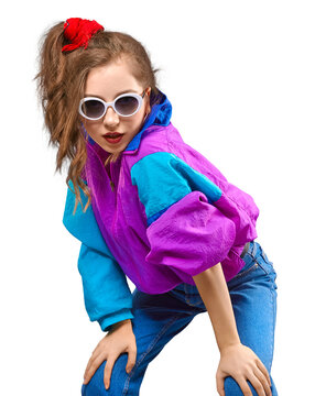 Fashion DJ girl in colorful trendy jacket from 90s. Cool Teenager shows strong face at the disco party of 80s vibes. Fashionable smiling young model on yellow color background. PNG.