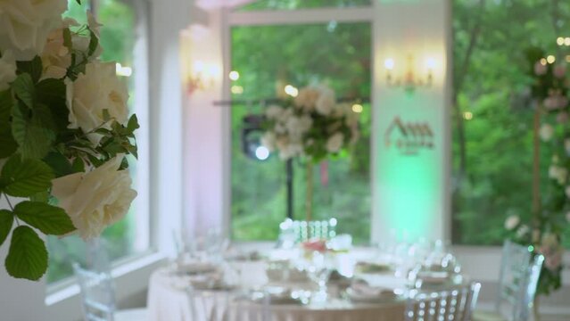 A Beautifully Decorated Wedding Reception Venue. A room with tables and chairs, flower decoration. Luxury event.