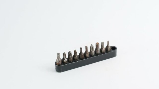 rusty screwdriver tips are laid out from the stand, move