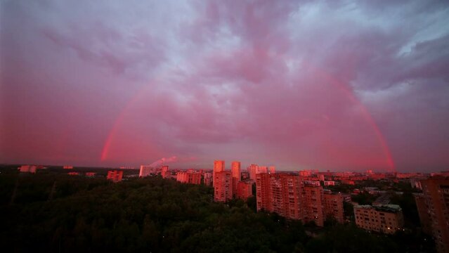 Rainbow over the district and wood of Moscow. Time lapse