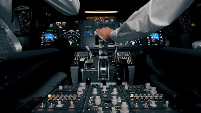 close-up hand of the pilot captain presses the buttons on the control panel to start the engine of the plane Flight simulator close-up