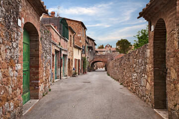 San Quirico d'Orcia, Siena, Tuscany, Italy: old street in the picturesque ancient town - 695094552