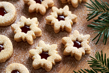 Star shaped Linzer Christmas cookies filled with strawberry marmalade and dusted with sugar
