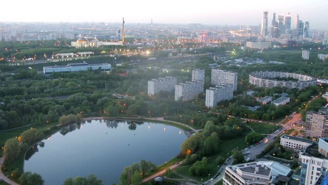 Cityscape with houses around pond at evening in Moscow