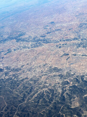 Airplane view. Aerial landscape. Small towns, roads and fields. Scenic top view of earth. High in the sky. Traveling by plane. Amazing beauty of nature.	