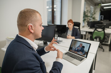 Business partners are talking in sign language to a video call. Two men at a remote business meeting. - obrazy, fototapety, plakaty