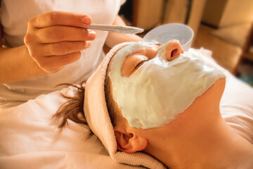 alginate mask, skin care procedure, a doctor in a cosmetology office applies an alginate mask to a...