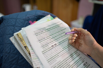 Woman Studying from Her Notes with Pen in Hand