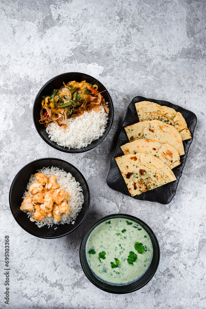 Wall mural rice with fried chicken fillet, vegetables and tuna shavings with kefir soup and flatbread.